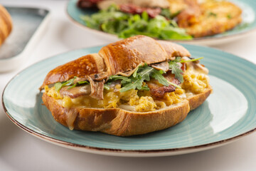 Breakfast of Fresh croissants with Turkey, mayo, and pickles   