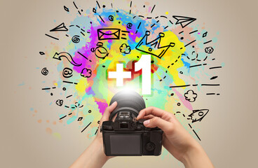 Close-up of a hand holding digital camera with abstract drawing concept