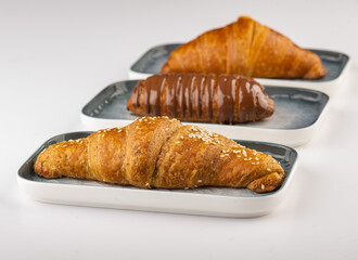 Fresh tasty croissants  of Cheese, Thyme and Chocolate on a plate 