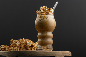 A glass of coffee latte with whipped cream, caramel popcorn, Popcorn Frappe 