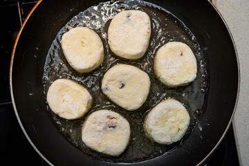 fresh tasty cheese pancakes cheesecakes are fried in a pan, ukraine traditional food