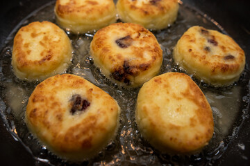 fresh tasty cheese pancakes cheesecakes are fried in a pan, ukraine traditional food