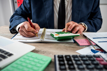 closeup of accountant hand work with accountancy document chart and diagram