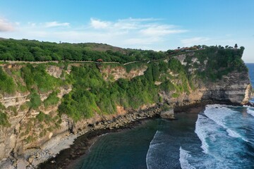 Panorama shot of the spectacular temple complex Pura Luhur in Uluwau on Bali, along the majestic, green-covered cliffs that flow into the sea.