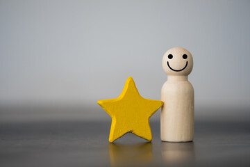 Wooden figures peg doll standing together with a yellow star. Talent, Human resources. Stand out...