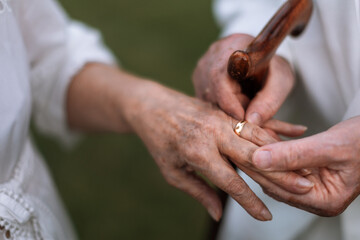 Close-up of seniors hands with wedding rings during their marriage.