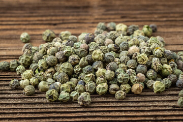 Dried spices green pepper on a wooden board