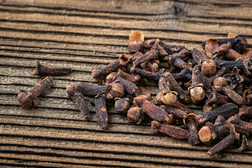 Clove spice on a wooden board, Syzygium aromaticum