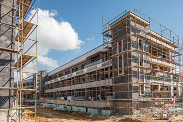 Construction scaffolding built on a new apartment building. new construction under construction