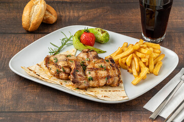 Spicy grilled chicken on a white porcelain plate