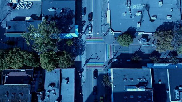 aerial birds eye view over gay pride LGBTQ downtown community with iconic 3 painted road flags define sexuality for the village of Davie Bute on sunny summer day in Vancouver Canada Jim Deva Square1-2