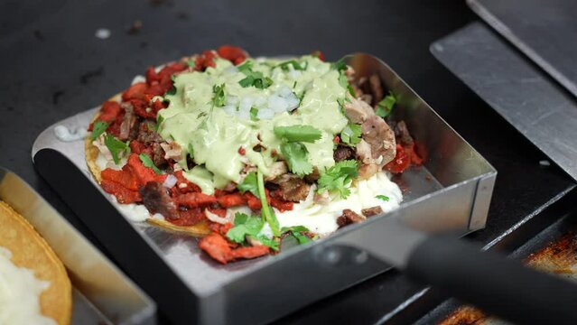 Isolated close up of a mulita before putting the top on - food truck series