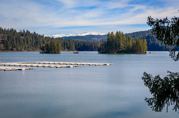 Jenkinson Lake and snow capped Sierra Nevada Mountains in Northern California