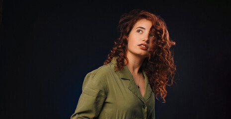 Portrait of young redhead woman, studio shoot.