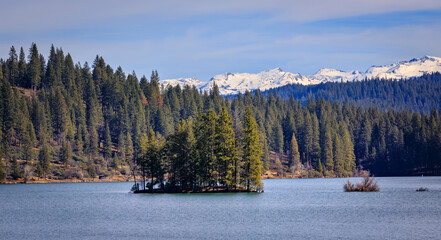 Jenkinson Lake and snow capped Sierra Nevada Mountains in Northern California