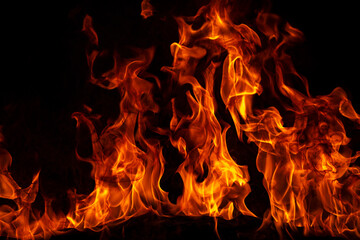 Texture of fire on a black background. Abstract fire flame background, large burning fire.