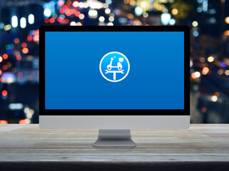 Service fix motorcycle with wrench tool flat icon on desktop modern computer monitor screen on wooden table over blur colourful night light traffic jam road, Business repair motorcycle online service