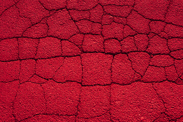 Surreal background of red cracked asphalt. Texture. 