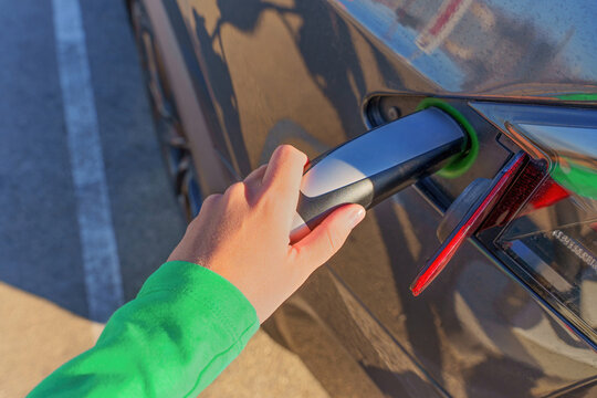 Human Hand Attaching Electric Vehicle Charging Connector