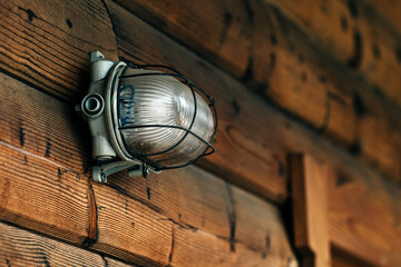 Outdoor wall light on lodging cottage wooden door