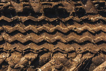 Agricultural tractor tire tracks in dirt road ground, top view