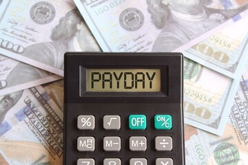 Fototapeta premium Top view image of money and calculator with text PAYDAY. Finance concept