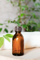 bottle mockup of essential oil sits on a table with a towel in the background. Body care and spa. Natural cosmetics. 
