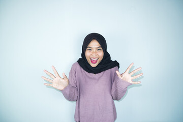 portrait of happy asian smiling wearing hijab isolated on light grey background. ramadan concept