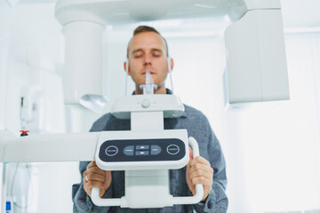 A young man underwent a CT scan of the jaw, a circular image of the jaw in modern dentistry. Radiology, panoramic scanner.