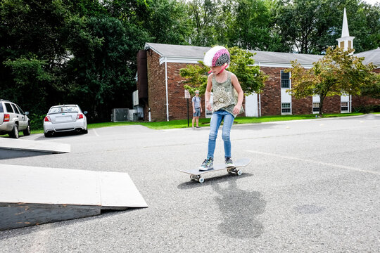 girl riding skateboard towards skate ramp