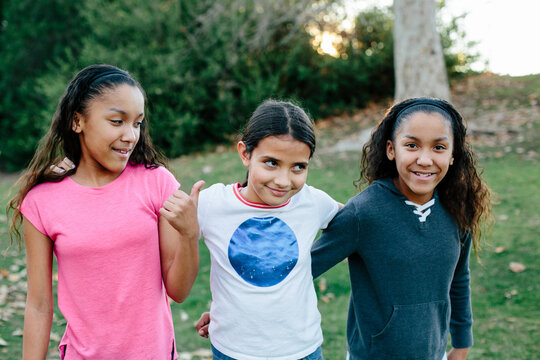 Candid moment with twins and cousin with arms around each other