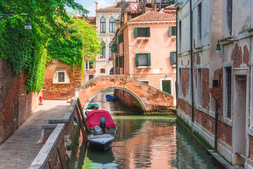Venice, Italy. Beautiful view on Venetian canal with old colorful buildings and bridge over channel in Venezia