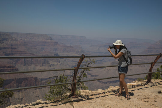 Woman taking pictures of the Grand Canyon