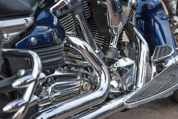 Fototapeta premium Motorcycle engine closeup. chrome engine parts. Shiny smooth details.