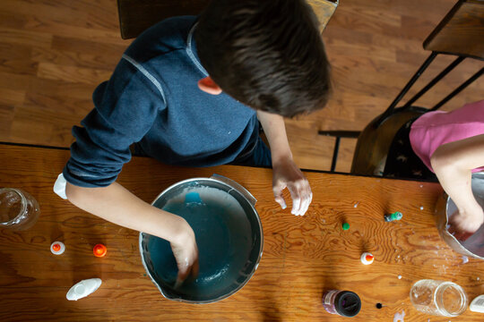 Tween siblings making slime at home