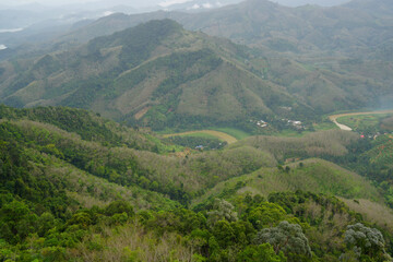 Landscape Green nature fog and misty cover around mountain valley seen from Skywalk Aiyerweng Famous landmark in Betong Yala southern thailand - in the morning - Travel and Sighseeing South east Asia 