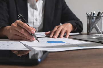 Business man hand analyze chart paper. Business and technology concept.