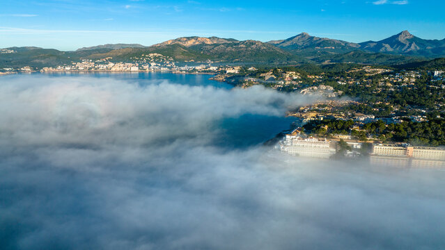 Spain, Majorca, Santa Ponca, Aerial view of thick fog floating in front of coastal town