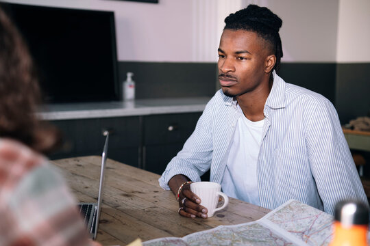 Businessman with colleague sitting at desk in office