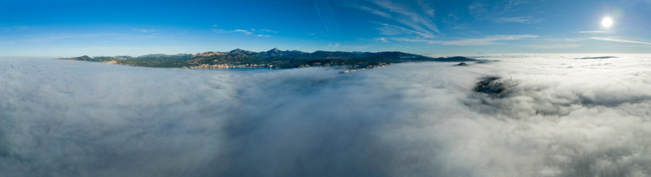 Spain, Majorca, Santa Ponca, Aerial panorama of thick fog floating in front of coastal town