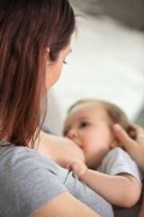 Fototapeta na wymiar a mother is breastfeeding a baby