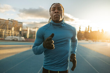 Young athlete running on sports track