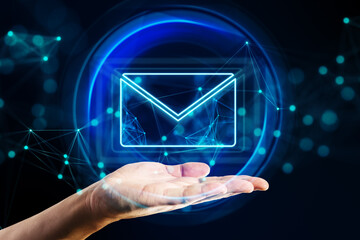 Mail, email and network communication concept with digital glowing envelope symbol in abstract sphere above human hand palm on abstract dark background with blurred dots