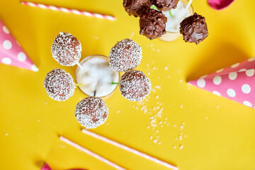 Festival birthday pink girl background with delicious homemade popcake coconut  chocolate cake pops on a yellow background, festival desserts, tasty food