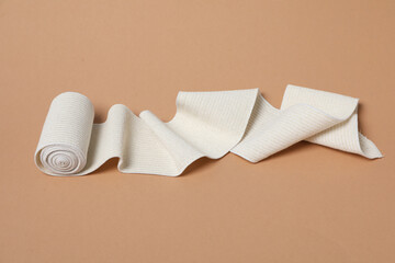 Help during an injury, elastic bandage on beige background