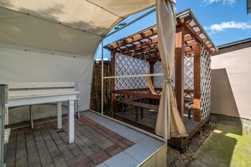interior of hall veranda or gazebo in wooden village vacation home with garden chairs