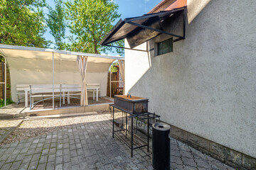 interior of hall veranda or gazebo in wooden village vacation home with garden chairs