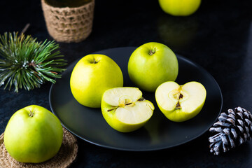 Ripe green apple fruits on dark stone table. Top view with copy space. Flat lay