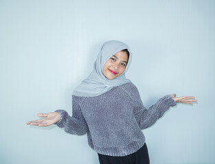 Excited Asian Muslim woman celebrating victory isolated over white background