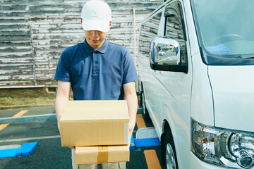 ダンボールを持った配達員